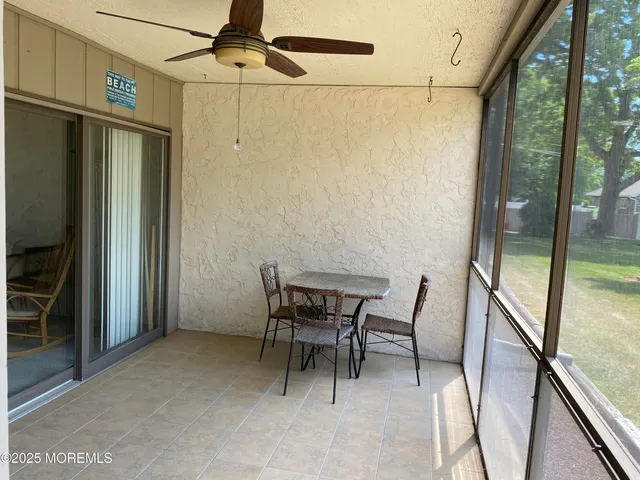 a view of a hallway with furniture and front door