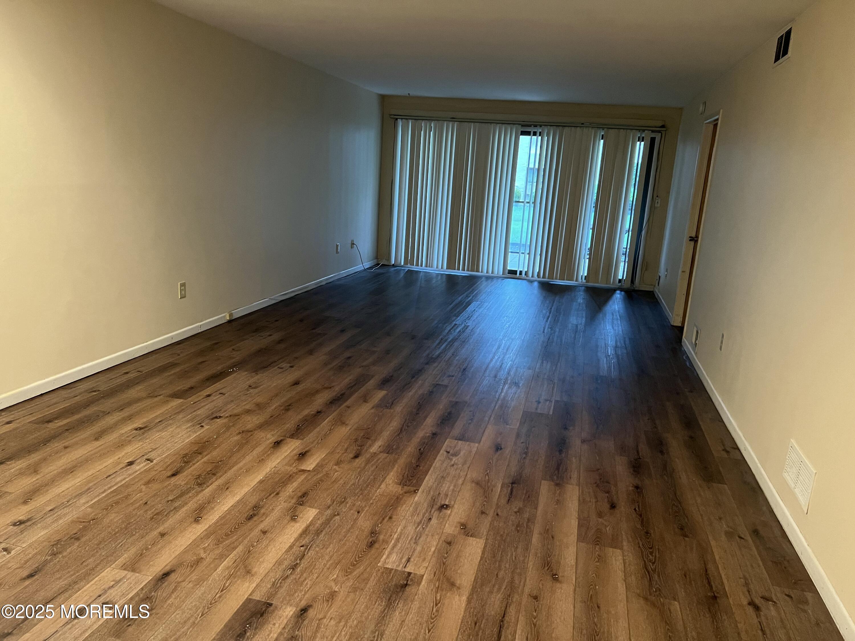 1501 Hulse Road, Unit 13 Point Pleasant, NJ 08742 - Photo 5 of 9 wooden floor in an empty room with a window