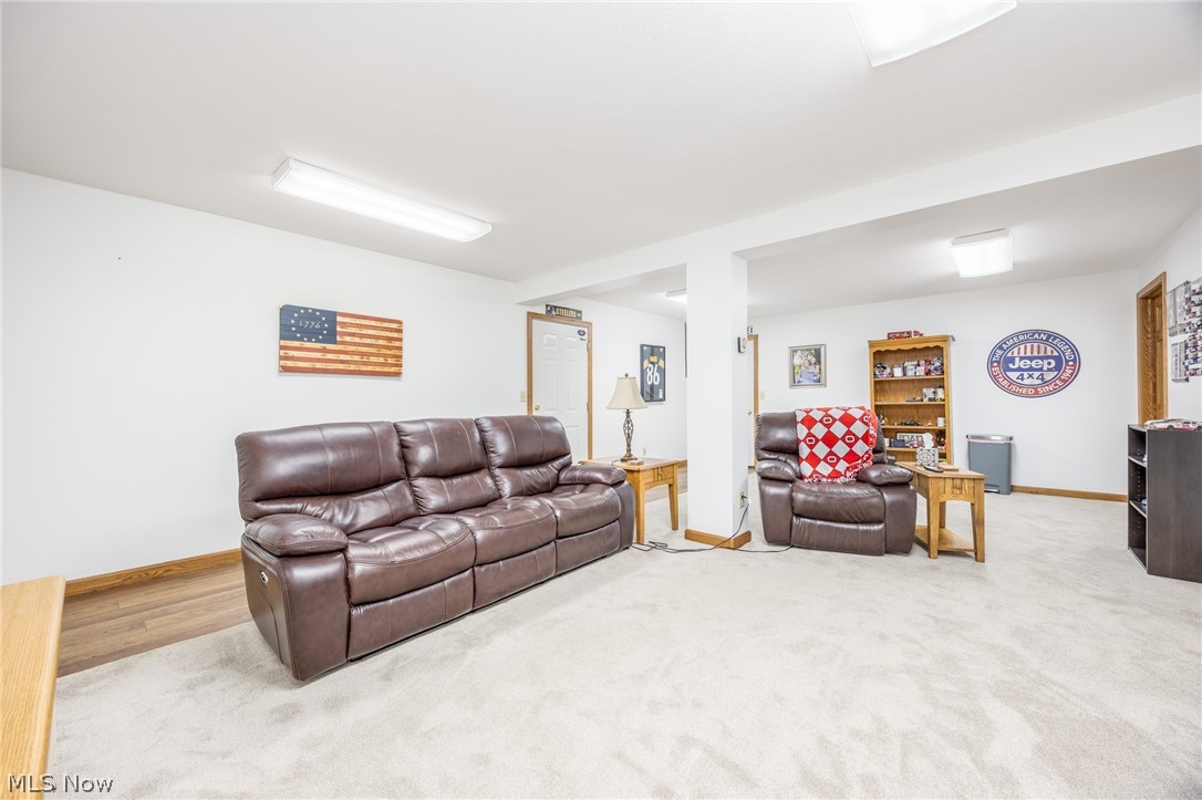 1602 Glendale Road, Unit 3 Marietta, OH 45750 - Photo 33 of 49 Lower level, carpeted living area featuring white walls and a wood-finish baseboard, illuminated by recessed lighting and a fluorescent ceiling fixture