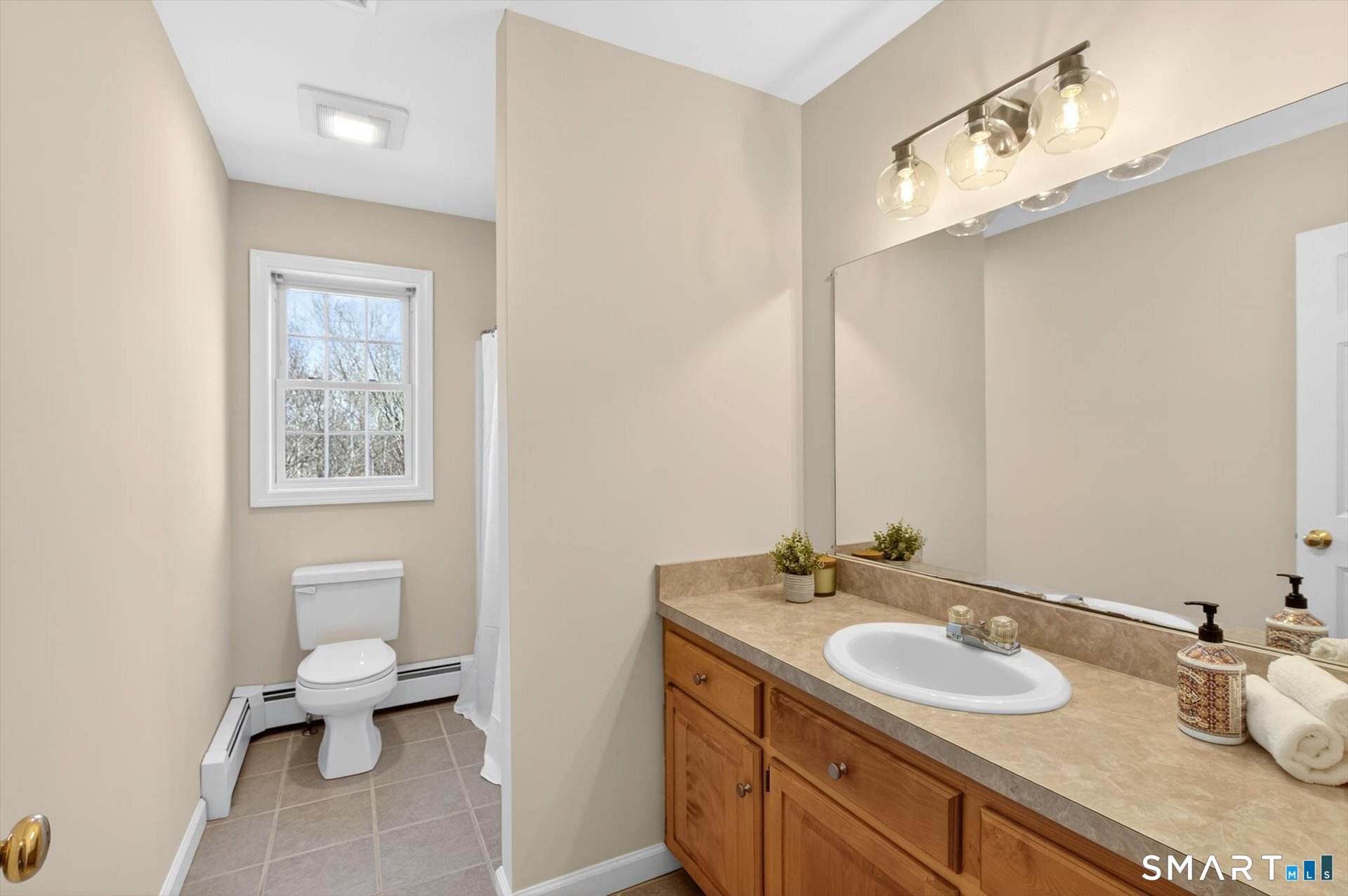 16 A Claire Hill Road Burlington, CT 06013 - Photo 18 of 37 a bathroom with a granite countertop sink a toilet and a mirror