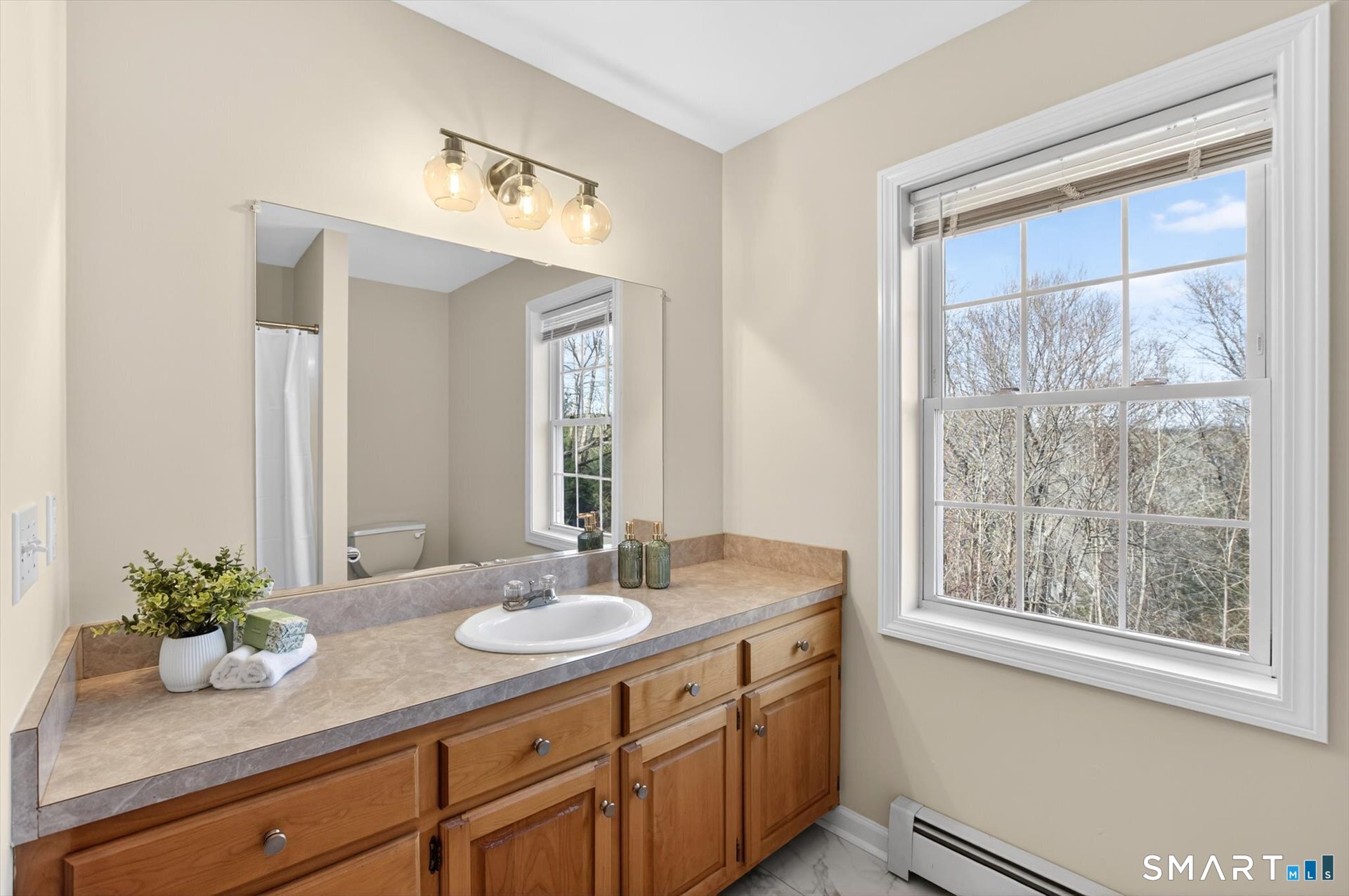 16 A Claire Hill Road Burlington, CT 06013 - Photo 25 of 37 a bathroom with a granite countertop sink a mirror and a window