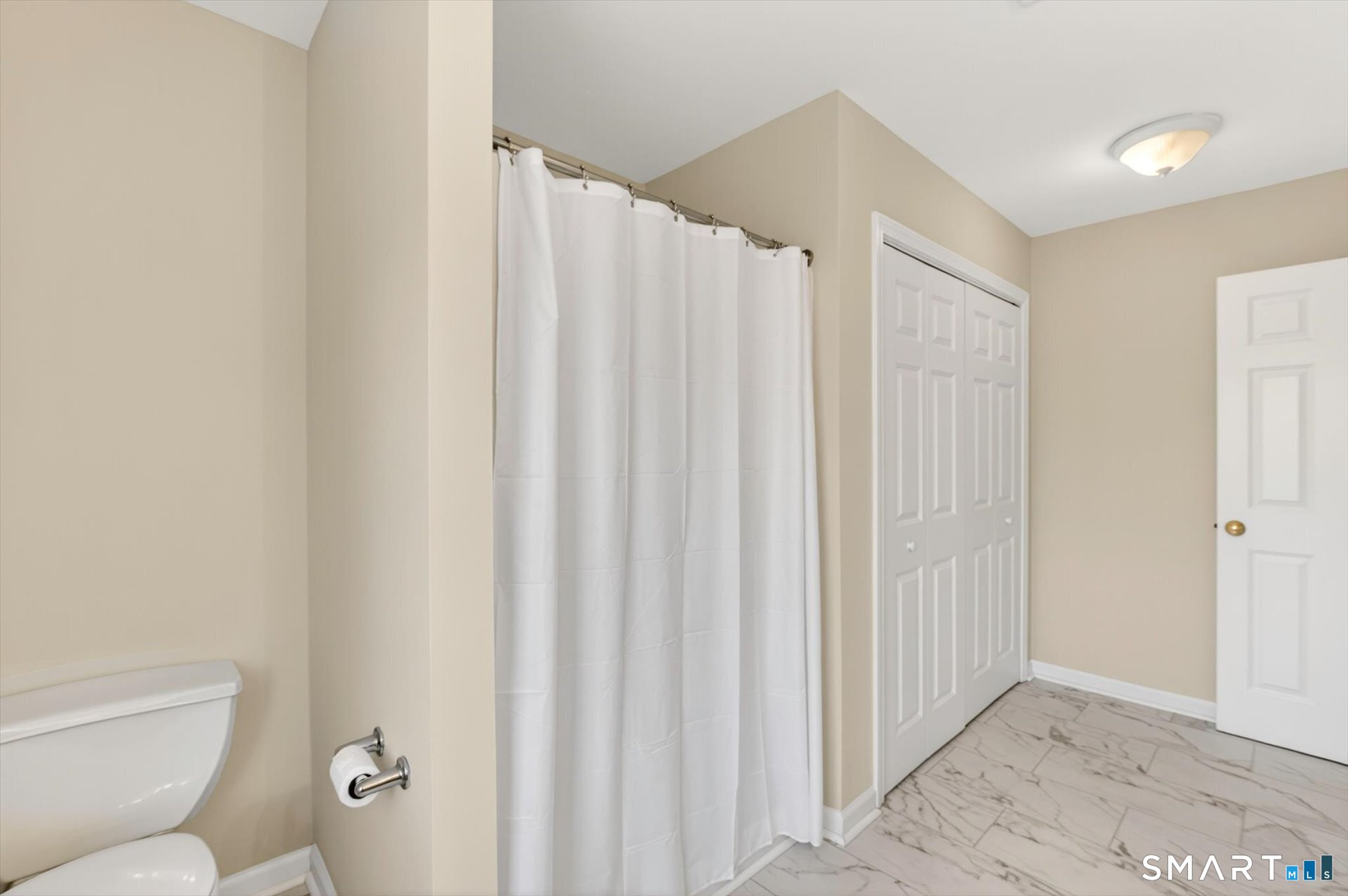 16 A Claire Hill Road Burlington, CT 06013 - Photo 26 of 37 a bathroom with a shower curtain and a toilet