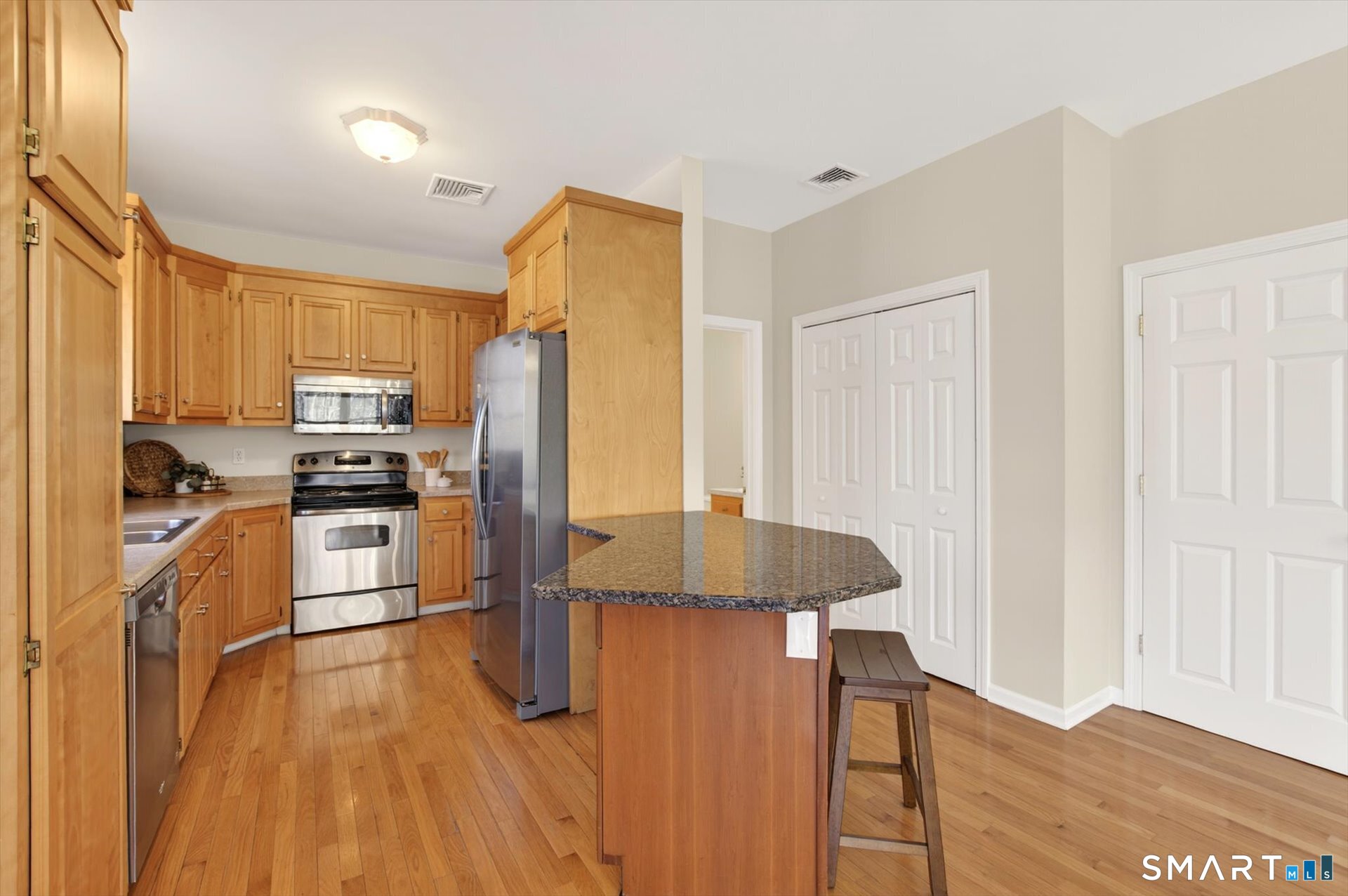 16 A Claire Hill Road Burlington, CT 06013 - Photo 8 of 37 a kitchen with granite countertop stainless steel appliances a refrigerator and a stove top oven