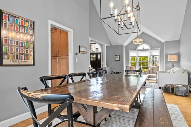 a dining room with furniture a rug and wooden floor