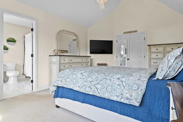 a bedroom with a bed and a flat screen television