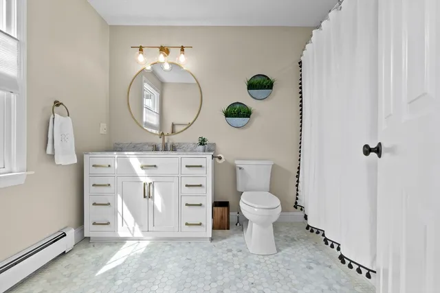 a view of bathroom with a toilet a sink and a mirror