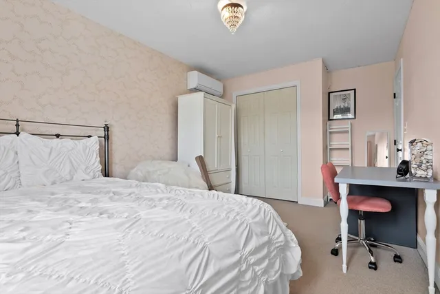 a bedroom with a bed and a desk