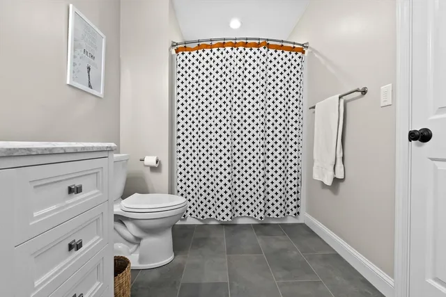 a bathroom with a toilet and a shower