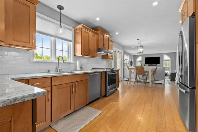 a kitchen with stainless steel appliances granite countertop sink stove top oven and cabinets