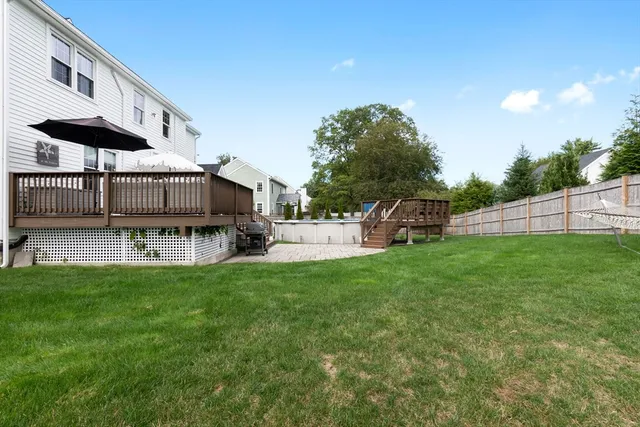 a view of a house with backyard and sitting area
