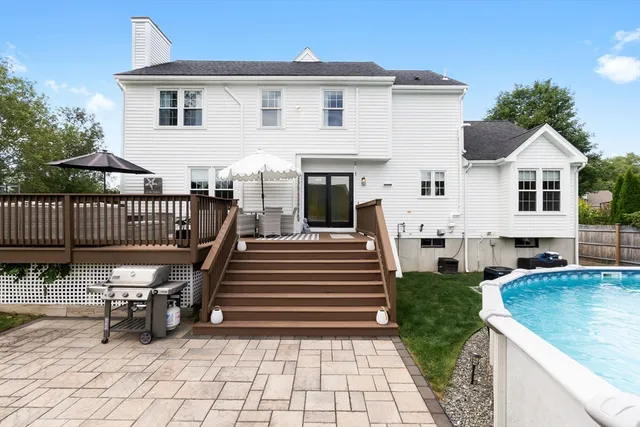 a view of a house with wooden deck and furniture