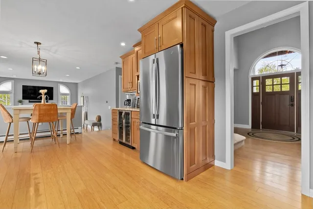a kitchen with stainless steel appliances a refrigerator and a stove top oven