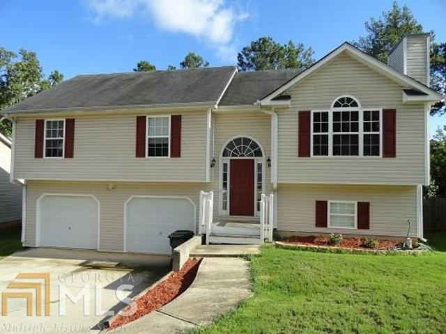 162 Whetstone Way, Unit 55 Villa Rica, GA 30180 - Photo 1 of 1 a front view of a house with a yard