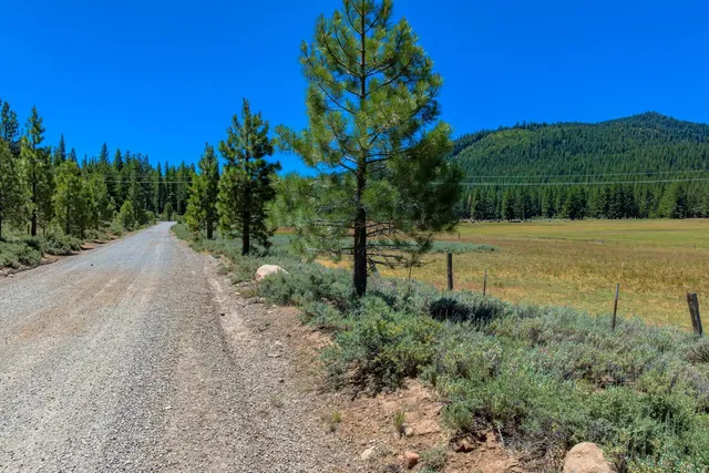 a backyard of a house with a yard and outdoor seating
