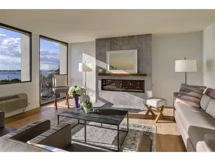 a living room with furniture a flat screen tv and a table