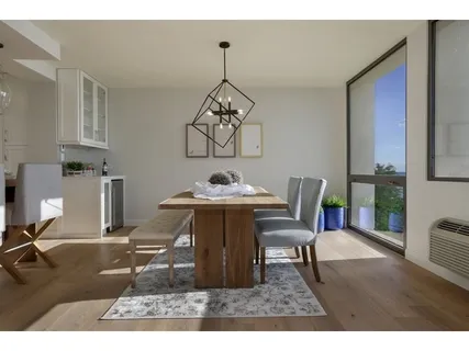 a dining room with furniture a chandelier and wooden floor