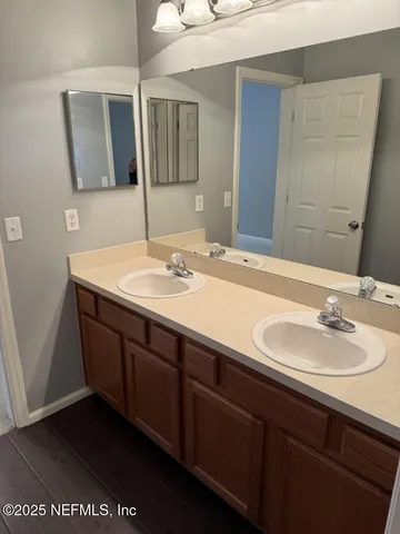 an empty room with closet and a chandelier fan