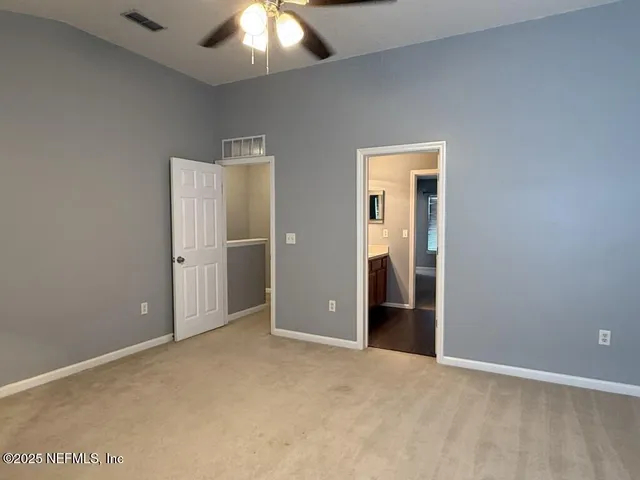 an empty room with wooden floor and closet