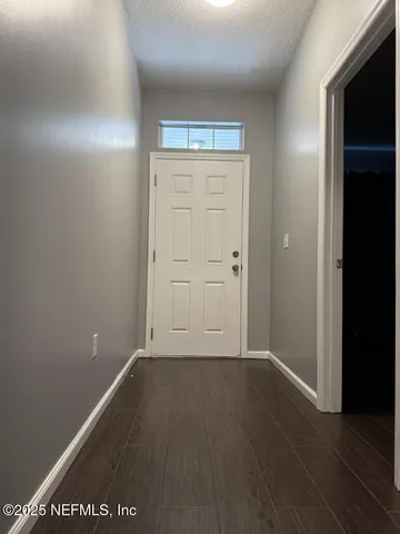 an empty room with wooden floor