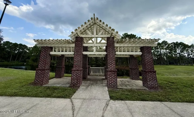 a view of a lake with a bench in a patio