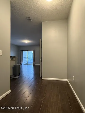 a view of a room with wooden floor and a sink
