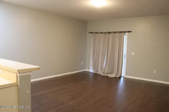 a view of a room with wooden floor