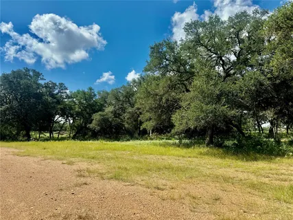 a view of yard with swimming pool and green space