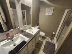 a bathroom with a sink toilet and a mirror