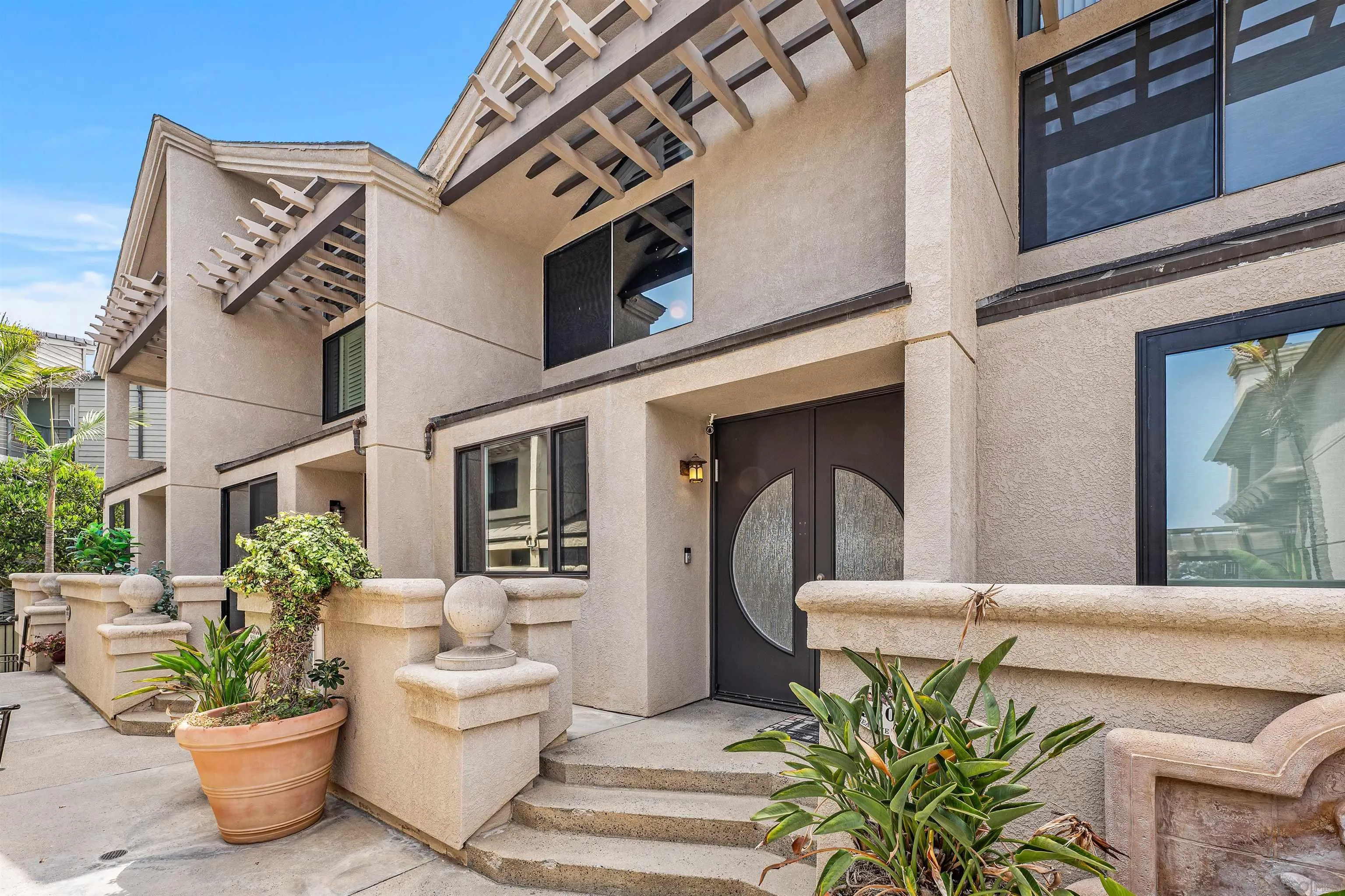 920 Sealane Drive, Unit B Encinitas, CA 92024 - Photo 2 of 10 a view of a patio with couches table and chairs and potted plants