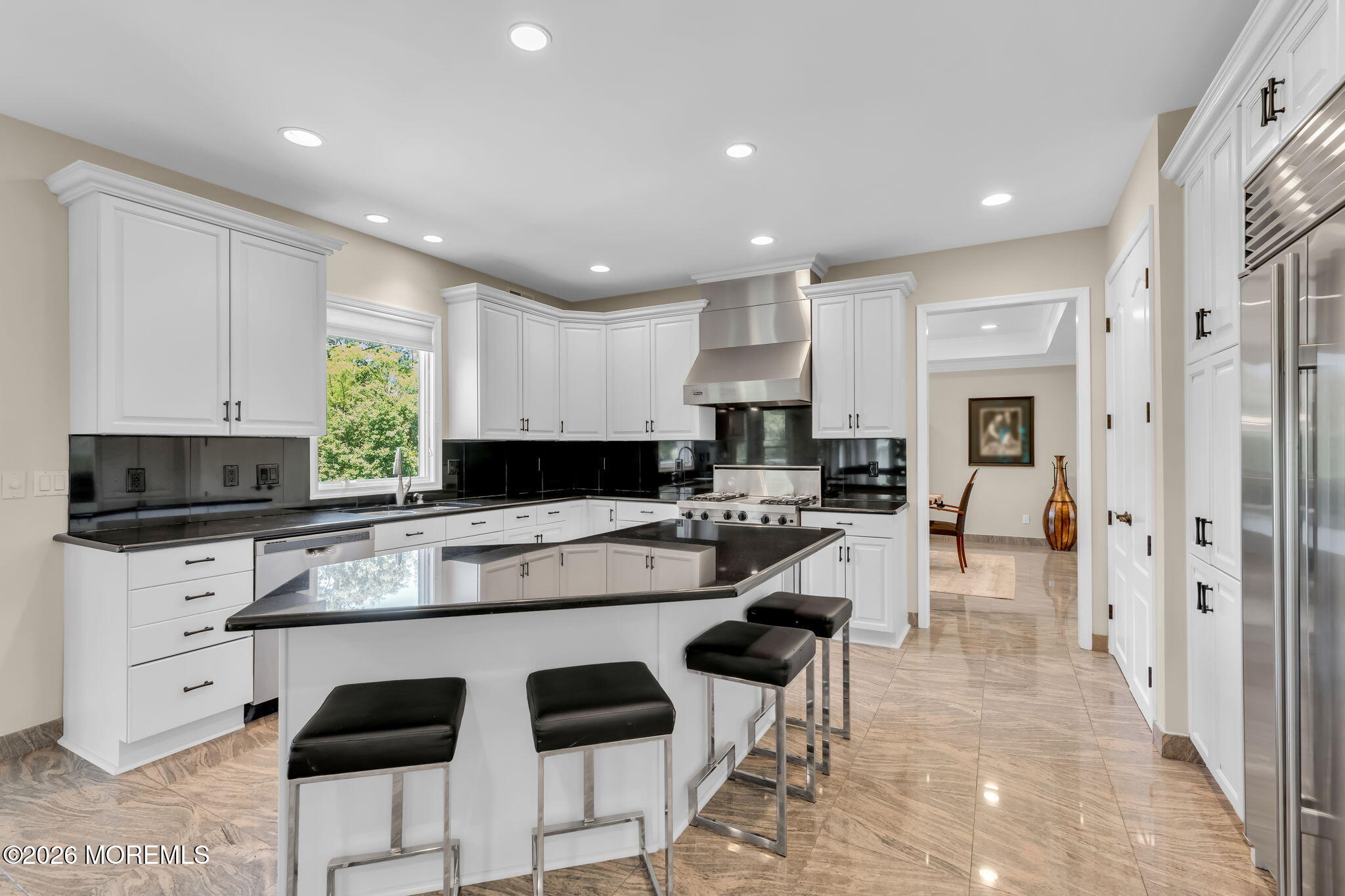 14 Diamond Hill Road Marlboro, NJ 07746 - Photo 20 of 79 a kitchen with stainless steel appliances kitchen island granite countertop a stove a sink a refrigerator and white cabinets