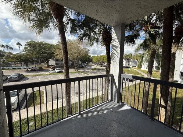 a view of balcony with palm trees