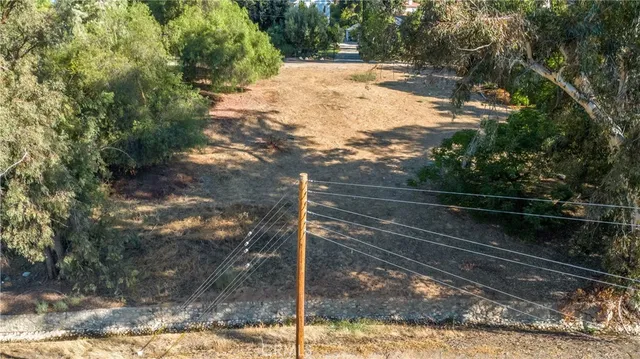 a view of a yard with wooden fence