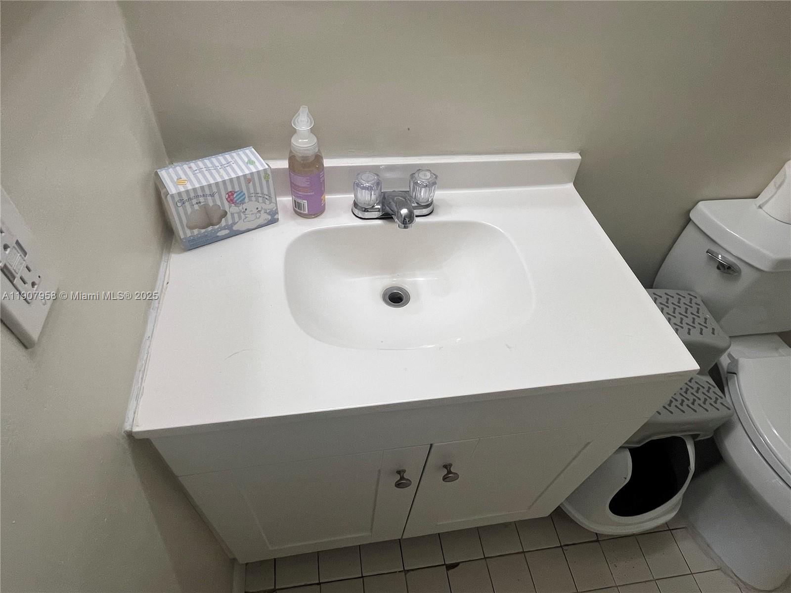 1500 Jefferson Drive, Unit 1500F Homestead, FL 33034 - Photo 16 of 22 a bathroom with a sink and a mirror