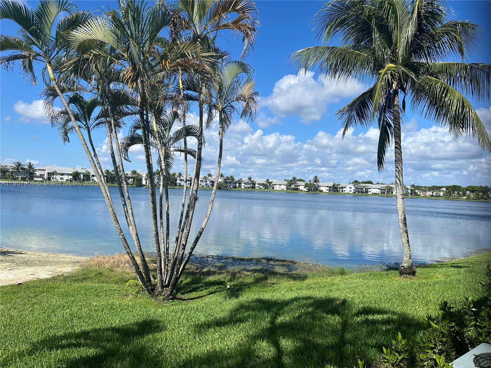 1500 Jefferson Drive, Unit 1500F Homestead, FL 33034 - Photo 2 of 22 a view of swimming pool with a yard and palm trees