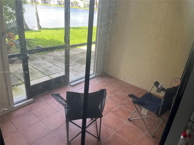 a view of a room with a table and chairs