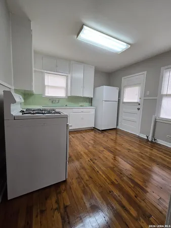 a view of a kitchen with wooden floor