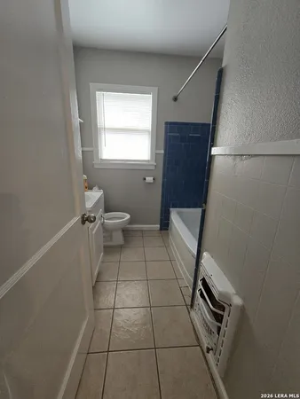 a bathroom with a toilet sink and window