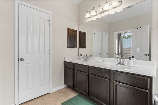 a bathroom with a double vanity sink and a mirror