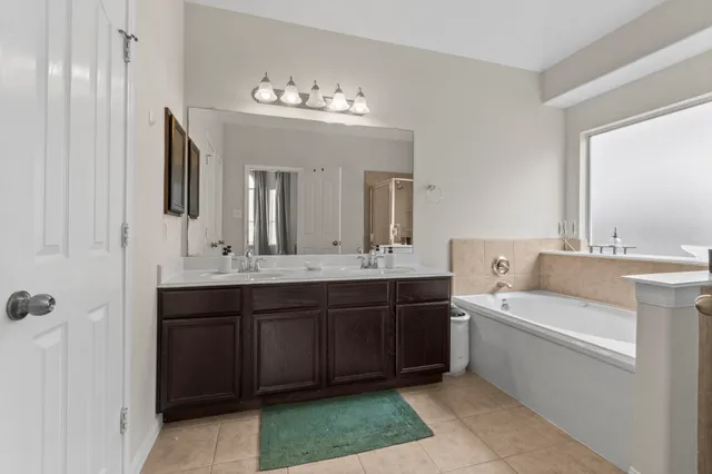 a spacious bathroom with a double vanity sink double and mirror