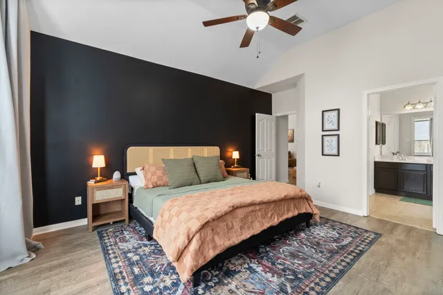 a bedroom with a bed and a chandelier