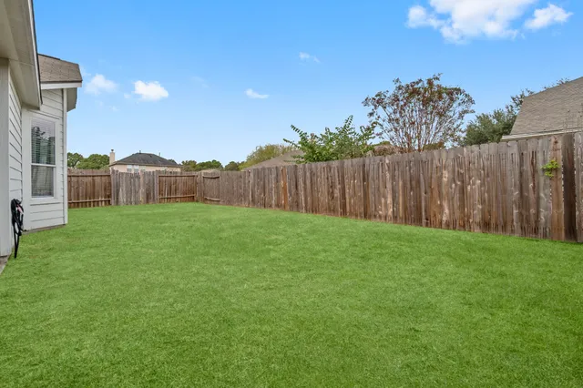 a view of a yard with a house in the background