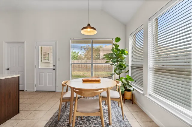 a view of a dining room with furniture and a window