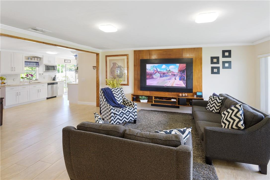 22202 Southwest 58th Avenue Boca Raton, FL 33428 - Photo 3 of 39 a living room with furniture and a flat screen tv