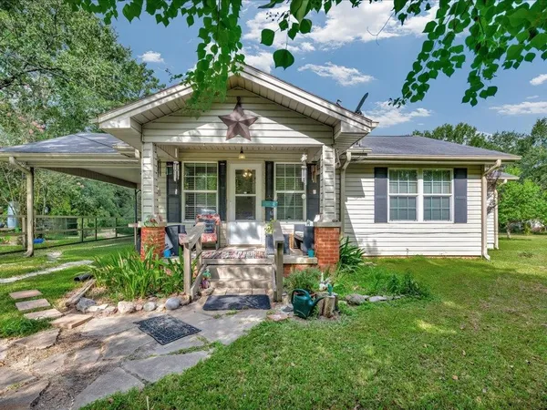 a view of a house with backyard sitting area and garden