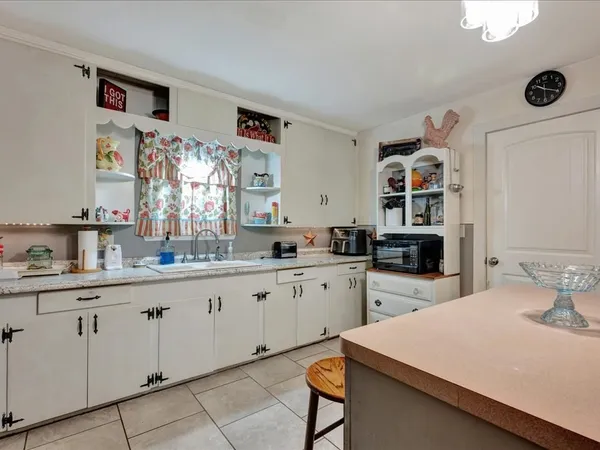 a kitchen with sink cabinets and wooden floor