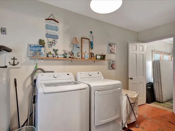 a view of washer and dryer with kitchen in the background