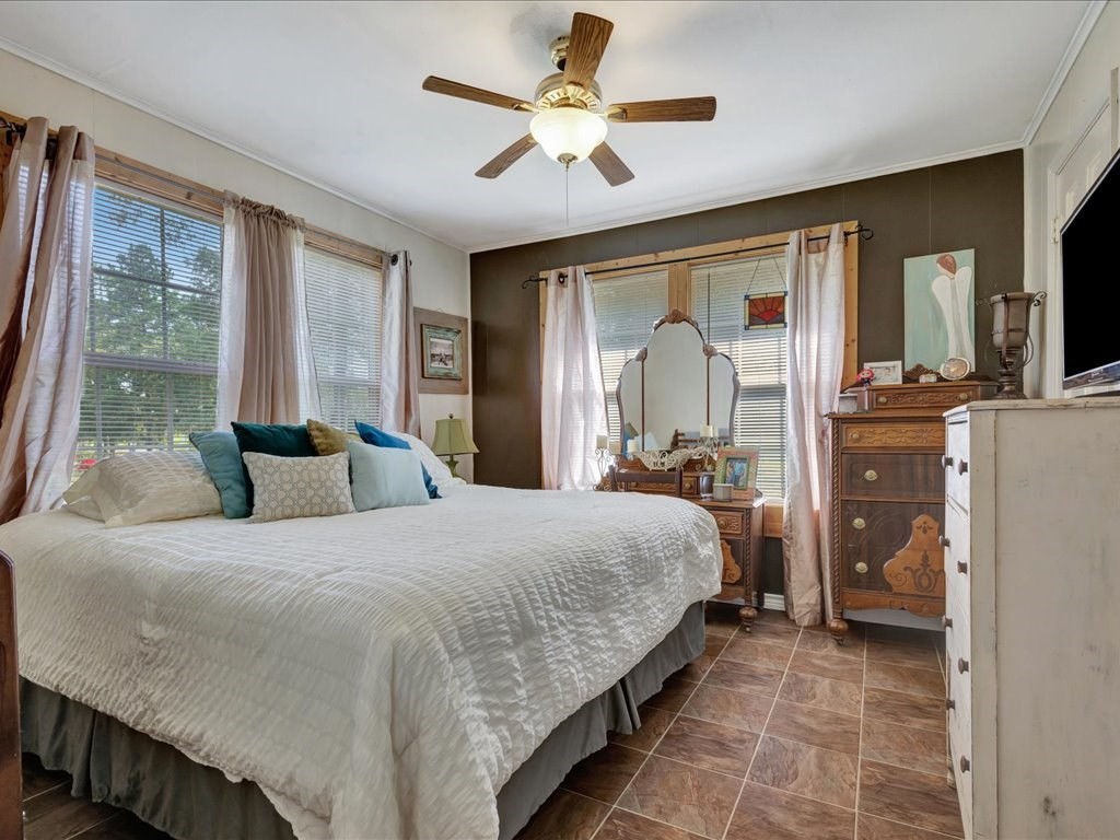 635 Oscar Berry Road Lufkin, TX 75904 - Photo 17 of 36 a bedroom with a bed and glass walk in closet