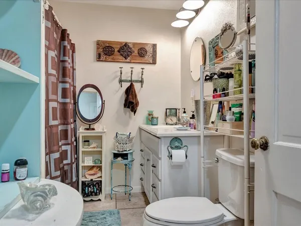 a bathroom with a toilet a sink and a mirror