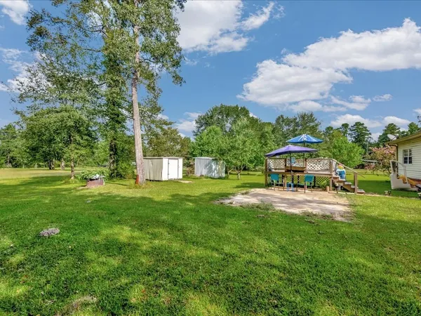 a view of a house with a yard and sitting area
