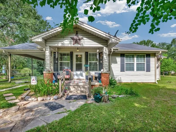 a view of a house with backyard sitting area and garden